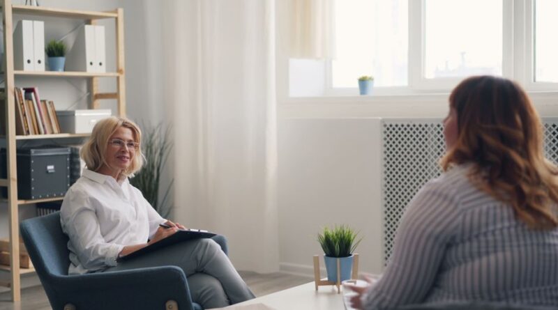 A therapist and a client engaging in a counseling session in a bright, modern office. - Photo by Vitaly Gariev on Pexels